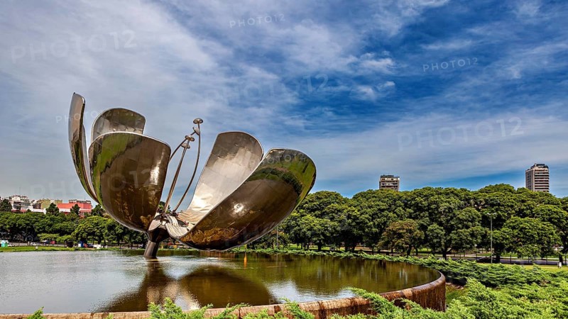 Architectural metal flower in a park with urban backdrop and blue sky, The lotus flower in Buenos Aires Argentina