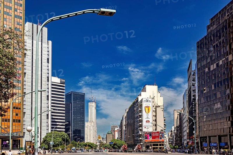 A busy city street with modern skyscrapers and heavy traffic under a blue sky, The city of Buenos Aires in Argentina