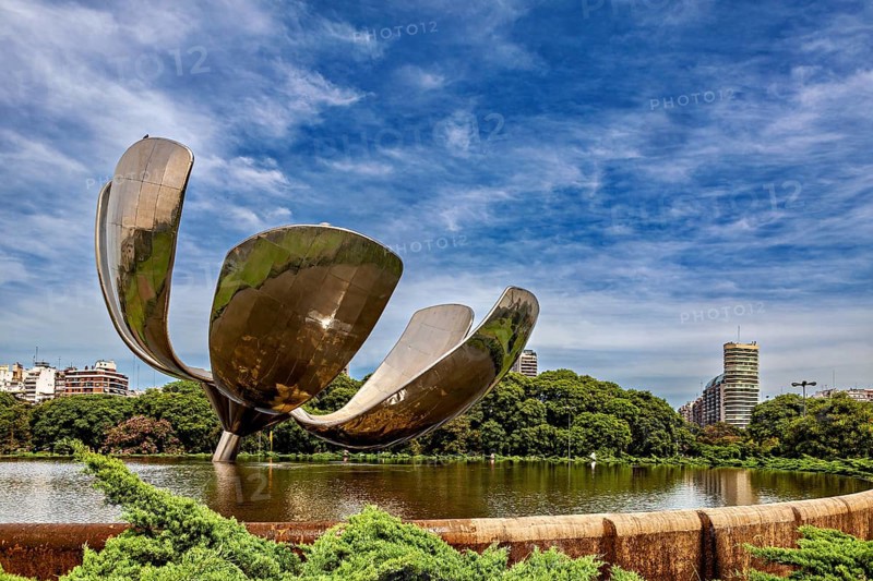 Imposing metallic flower with urban background, surrounded by a pond and trees, The lotus flower in Buenos Aires Argentina