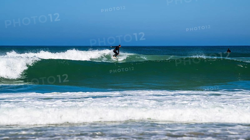 Surfer riding a wave on Contis beach, Saint Julien en Born, Saint-Julien-en-Born, Landes, France
