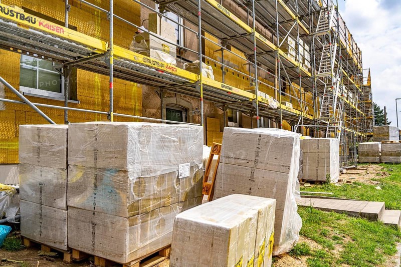 Energy refurbishment of an older residential building, thermal insulation with mineral wool insulation boards, mounted on the façade and then plastered, North Rhine-Westphalia, Germany