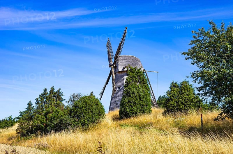 Historic windmill in an epic summer landscape near the burial ground of Stenhusbacken and the village of Sunnersberg near Lidköping, Västergötland, Västra Götalands län, Sweden