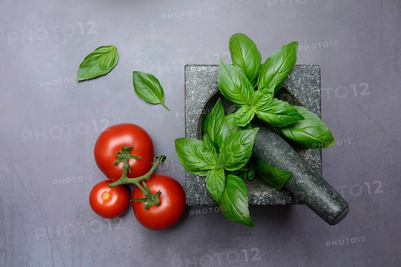 Basil in mortar and tomato, Ocimum basilicum, Solanum lycopersicum