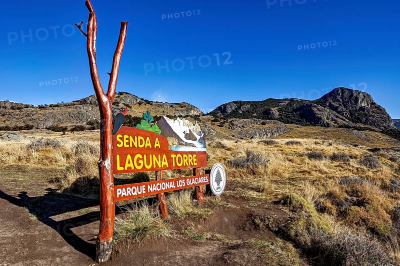 Signpost in the nature park pointing to a hiking trail under a clear blue sky, The Perito Moreno glacier in Argentina