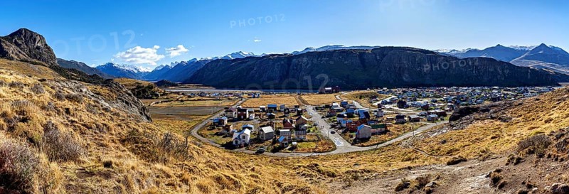 Panoramic view of a village in the valley, surrounded by high mountains and dry grassland under a clear sky, The village of El Chalten in Patagonia Argentina