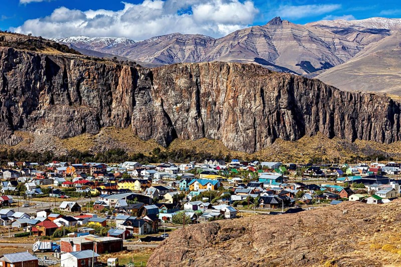 Village with colourful roofs at the foot of impressive cliffs and mountains in the background, the village of El Chalten in Patagonia Argentina