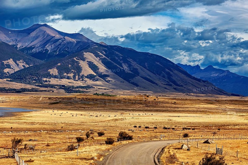 Wide plains with a winding road and a majestic mountain range in the background, the Patagonian landscape near El Chalten in Argentina