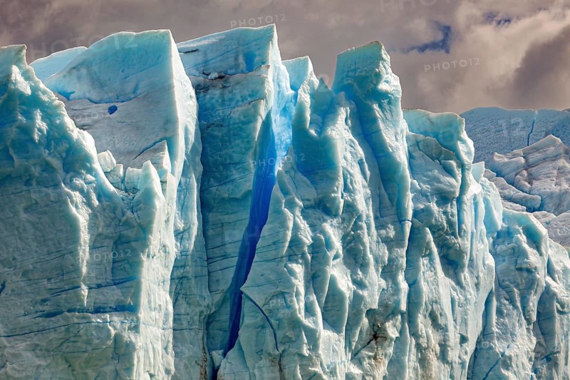 Majestic glacier wall under a cloudy sky in different shades of blue, The blue ice of the Perito Moreno Glacier in Patagonia Argentina