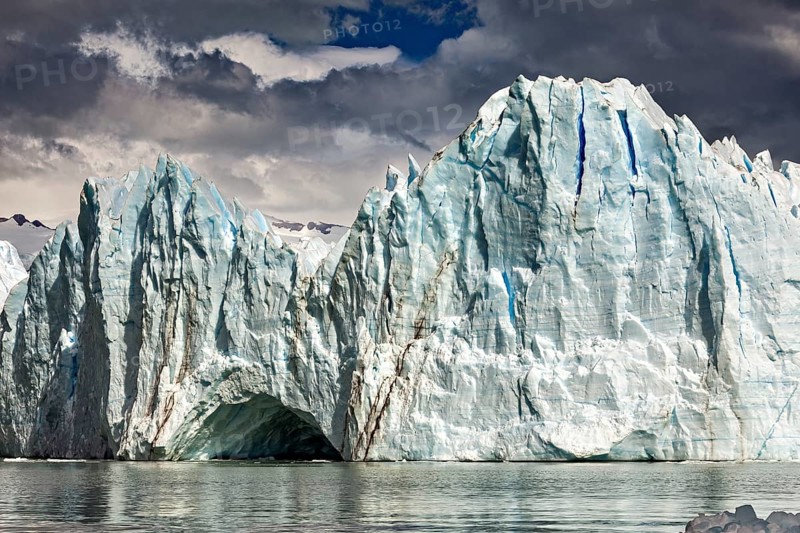 Majestic glacier front under a cloudy sky with mountains in the background, The glacier of Perito Moreno in Argentina