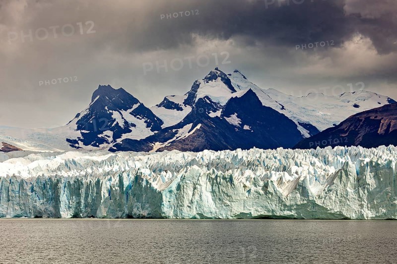 A powerful view of snow-covered mountains and glaciers under a gloomy sky, The Perito Moreno glacier in Argentina