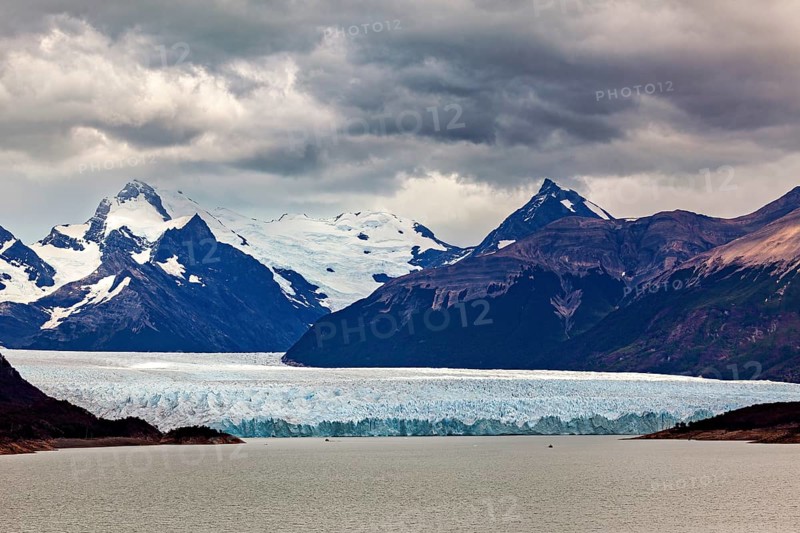Vast landscape with an impressive glacier and snow-covered mountains under a cloudy sky, The Perito Moreno glacier in Argentina