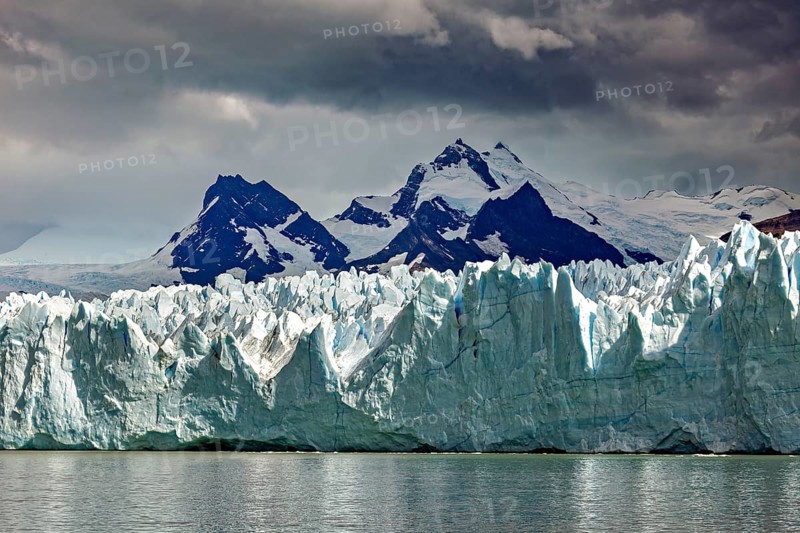 Imposing glacier merges with snow-covered mountains and sky, The Perito Moreno glacier in Argentina