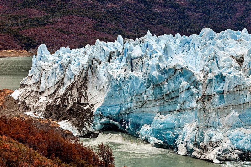 Massive glacier with blue peaks and autumnal foreland, The Perito Moreno glacier in Argentina