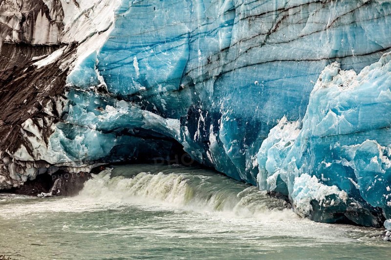 Close-up of a blue-white glacier wall with flowing water, The glacier of Perito Moreno in Argentina