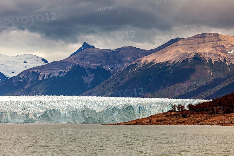 Impressive glacier front with dramatic sky and mountainous backdrop, The Perito Moreno glacier in Argentina
