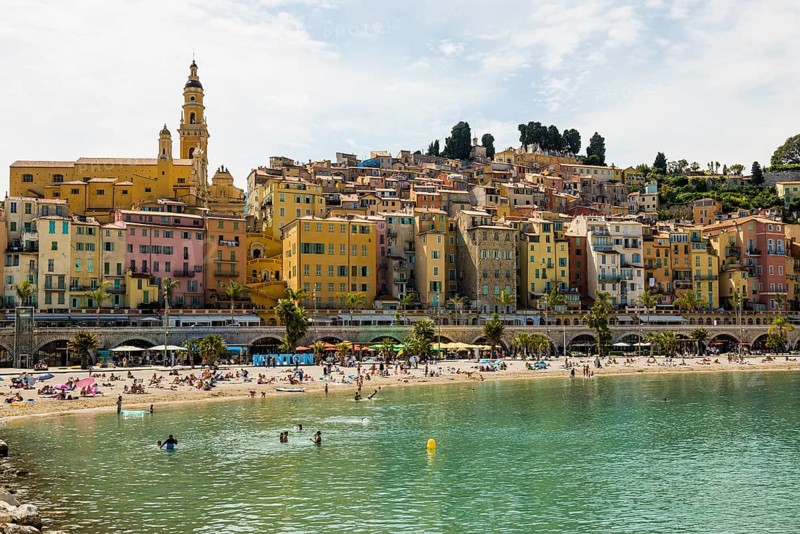 Town with colourful houses by the sea, Plage des Sablettes, Menton, Alpes Maritimes, Provence Alpes Cote d'Azur, French Riviera, South of France, France