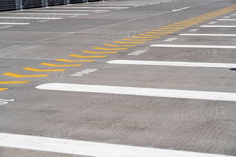 Markings on a car park deck, Direction of travel marking, Numbered parking spaces, Graphic