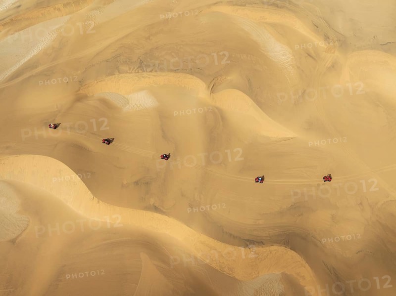 Quad bikes in the dunes of the Namib Desert in the vicinity of the coastal town of Swakopmund. Aerial view. Drone shot. Namibia