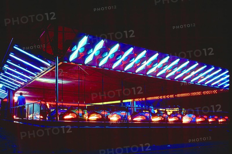 Illuminated bumper cars at night, New Jersey, USA