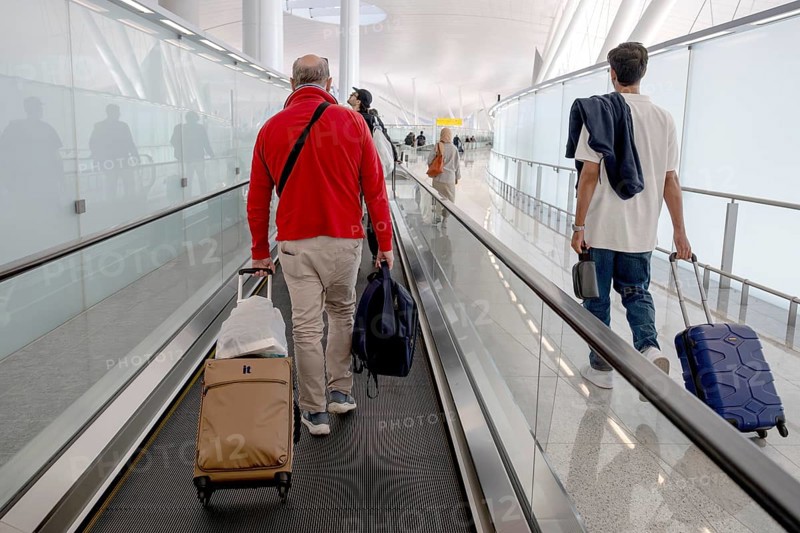 Airport moving walkway Passengers with hand luggage, Abu Dhabi, United Arab Emirates