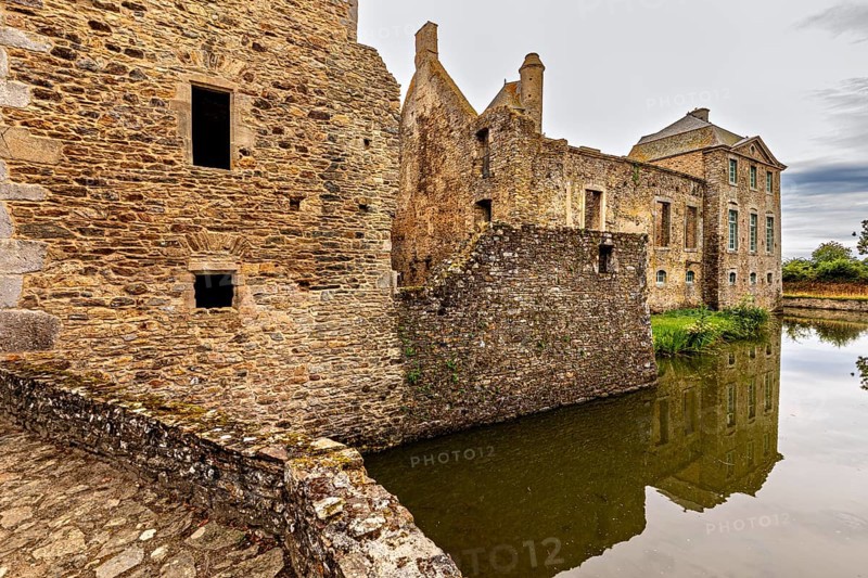 Historic castle with moat and reflection in a tranquil atmosphere, Gratot Castle in Normandy, France