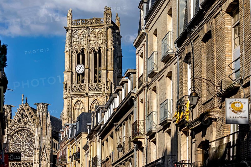 Gothic cathedral with impressive bell tower and stone architecture along the street under a blue sky, Dieppe Cathedral in Normandy, France