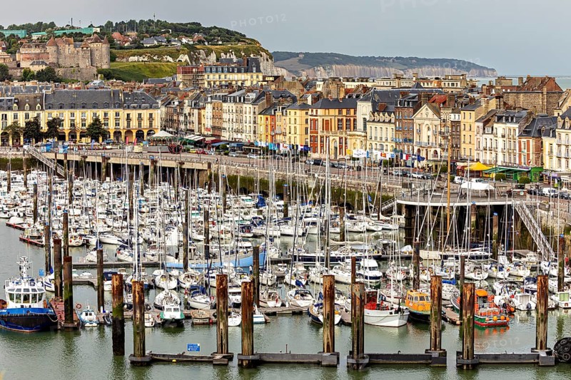Coastal view of a harbour with numerous boats, lined with historic buildings, The harbour of Dieppe in Normandy, France