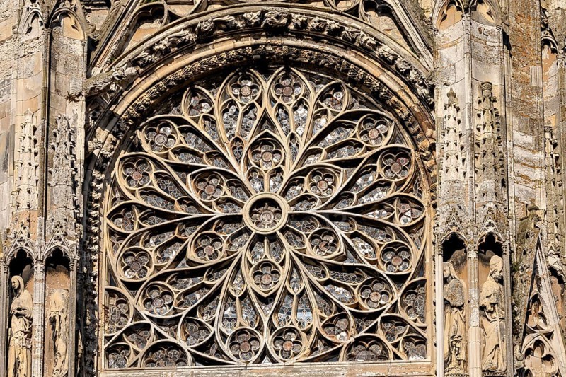 Elaborately designed Gothic rose window with filigree ornaments and stained glass, Dieppe Cathedral in Normandy, France