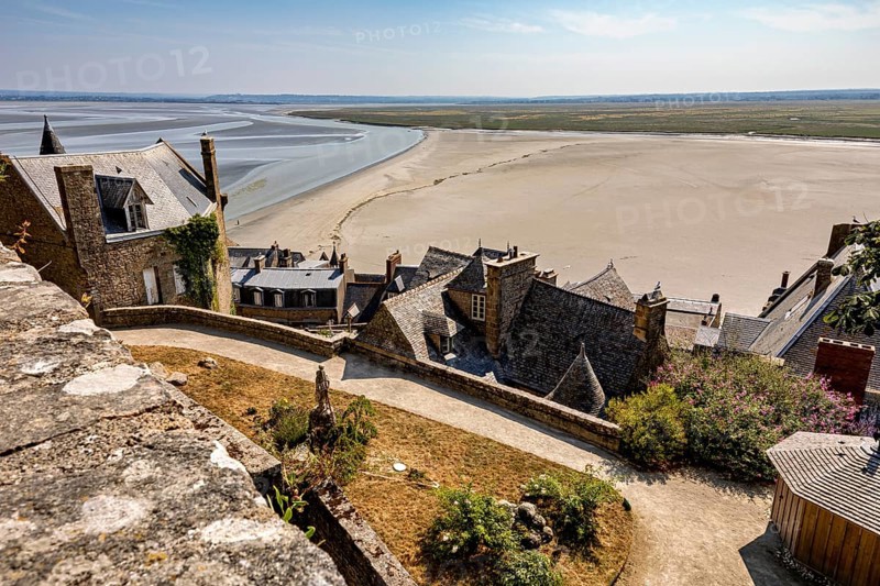 View from Mont Saint-Michel of sandy areas and the sea under a clear sky, Mont Saint Michel in Normandy, France