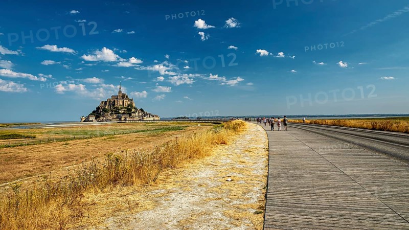 The monastery of Mont Saint-Michel in the distance under a clear sky and slightly cloudy, Mont Saint Michel in Normandy, France
