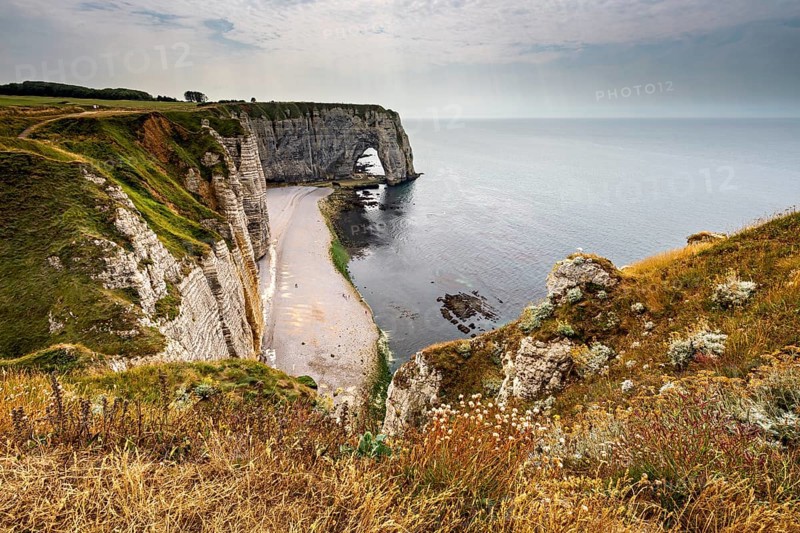 Spectacular cliff landscape with a small beach and sweeping ocean views, The cliffs and alabaster coast of Etretat in Normandy France