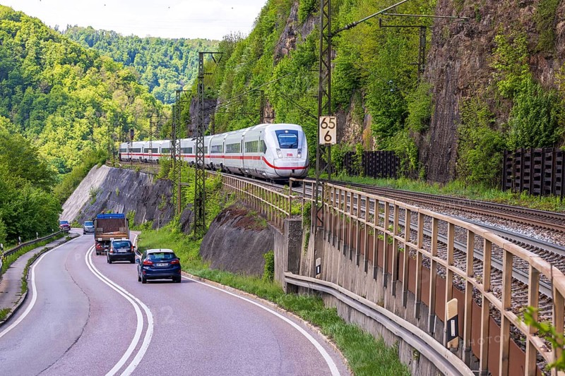 InterCityExpress ICE en route on the winding railway line of the Geislinger Steige. Landscape on the railway's Filstalline line in spring. Amstetten, Baden-Württemberg, Germany