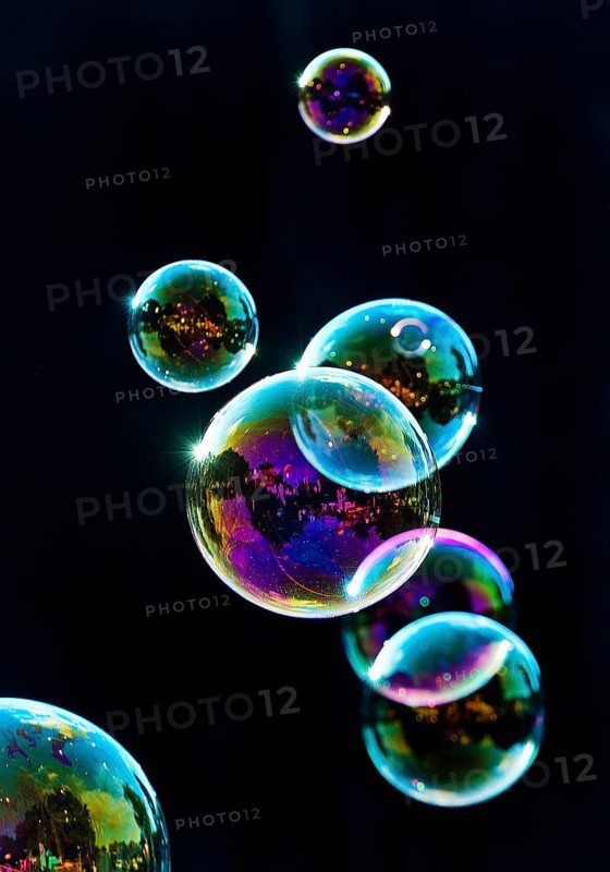 Iridescent soap bubbles in the colours of the rainbow against a black background, Recklinghausen, North Rhine-Westphalia, Germany
