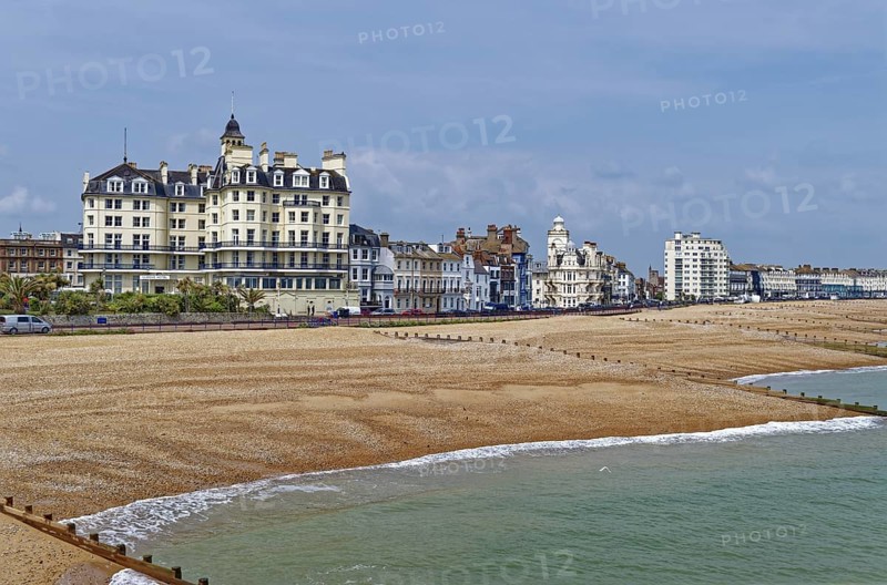 Beach and building on the seafront in Eastbourne, seaside resort on the English Channel, in the county of East Sussex, England, United Kingdom of Great Britain