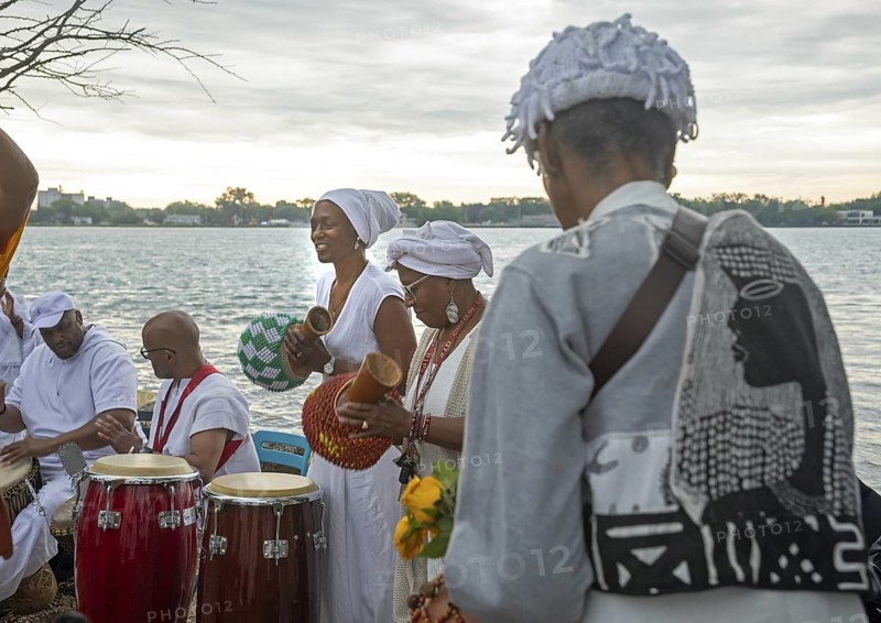 Detroit, Michigan - African-Americans gather on the banks of the Detroit River to commemorate ancestors lost in the slave trade. The annual event, known as The Carnival of the Spirit, is organized by the African Diaspora Ancestral Commemoration Institute