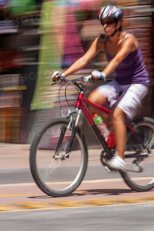Woman riding a bicycle, Photo with motion blur, City of Quito, Pichincha province, Ecuador, South America