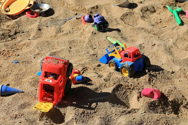 Playground, sandpit with plastic toys, vehicles, shovel