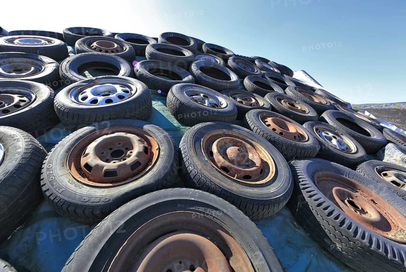 Old wheels, rims and tyres, used here to weigh down the cover of an agricultural silo
