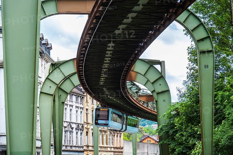 The Wuppertal suspension railway runs through Vohwinkel in front of buildings from the Wilhelminian era near the Hammerstein stop in Wuppertal, Germany