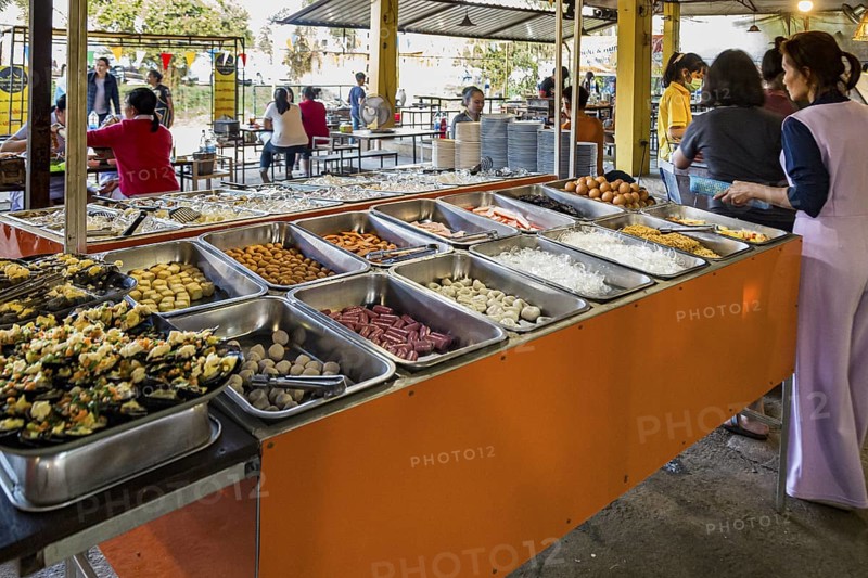 Selection of prepared foods available for customers at a buffet style outdoor restaurant in Chiang Rai province of Northern Thailand