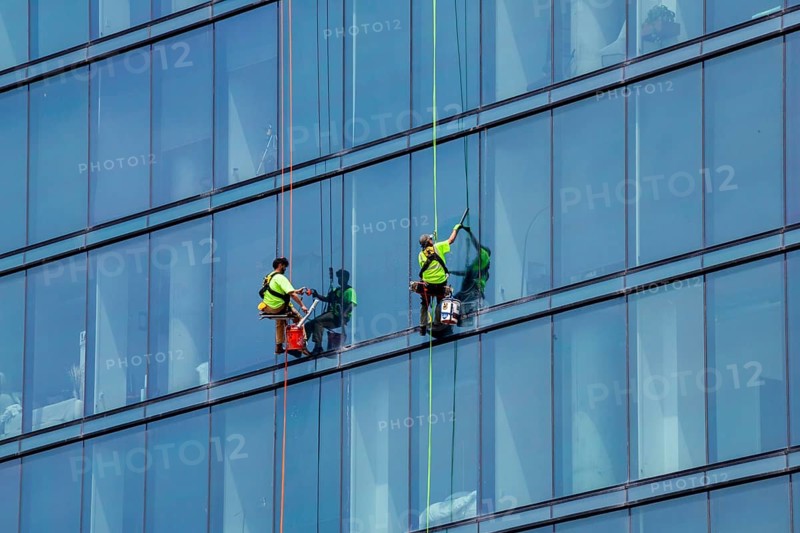 Detroit, Michigan - Window washers at the 25-story Residences Water Square luxury apartment building