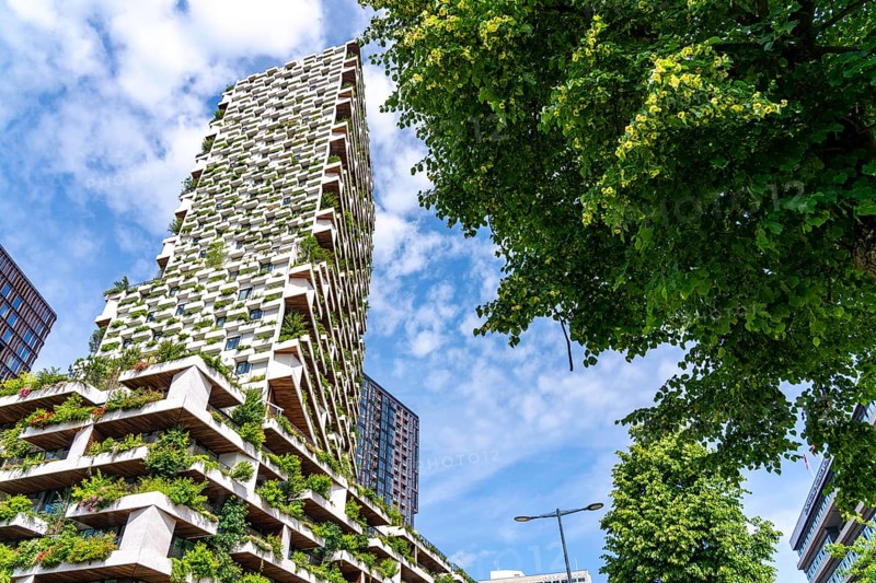 Wonderwoods residential tower, one of 2 green buildings, in Utrecht in the new Healthy Urban Quarter, at the central station, 105 metres high with 30 floors, Tower II, over 360 trees and over 9600 shrubs and flowering plants native to the region, all irrigated with collected rainwater, sponge city principle and monitored with sensors, Utrecht, Netherlands