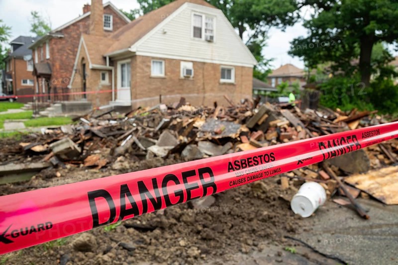 Detroit, Michigan - Signs warn of asbestos danger where a house was demolished. The house had been heavily damaged by fire a year earlier and was a neighborhood eyesore