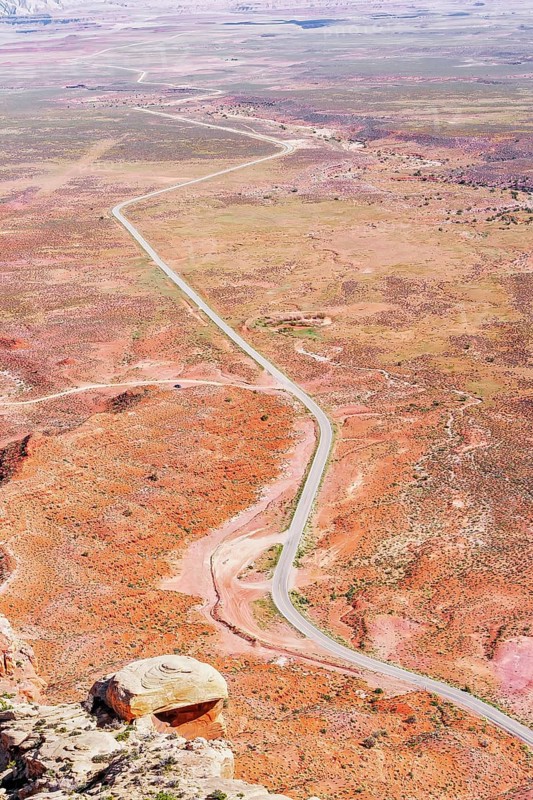 Winding roadway cutting through Valley of the Gods, Utah, USA