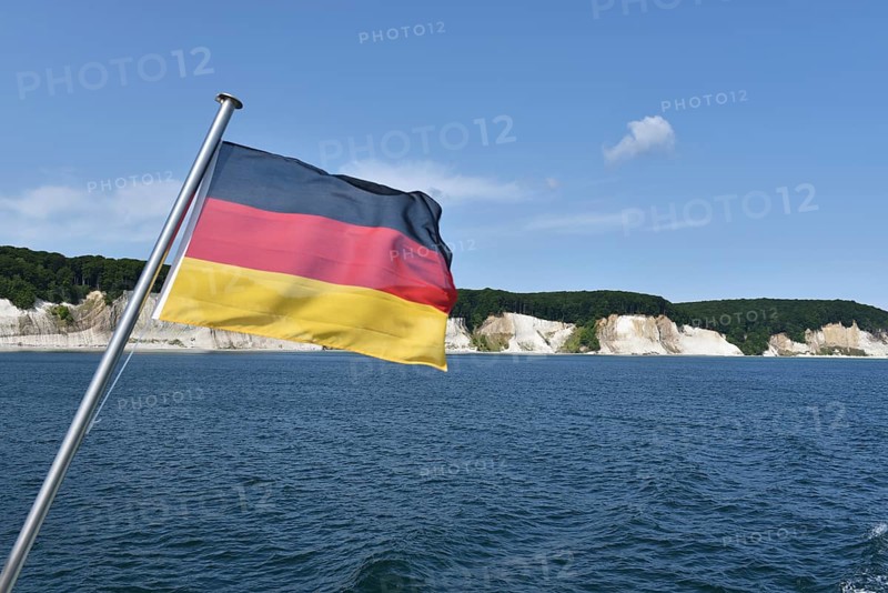 German flag in front of the chalk cliffs on Rügen, Mecklenburg-Western Pomerania, Germany
