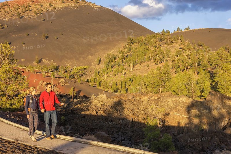 Couple walking on pathway, Sunset Crater Volcano National Monument, Flagstaff, Arizona, USA