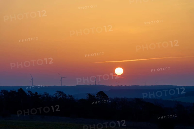 Landscape with sunrise over silhouettes of wind turbines on the horizon, Sodenberg, Hammelburg, Rhön, Bavaria, Germany