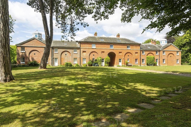 Stable block buildings converted to residential use, Sudbourne Hall, Suffolk, England, UK