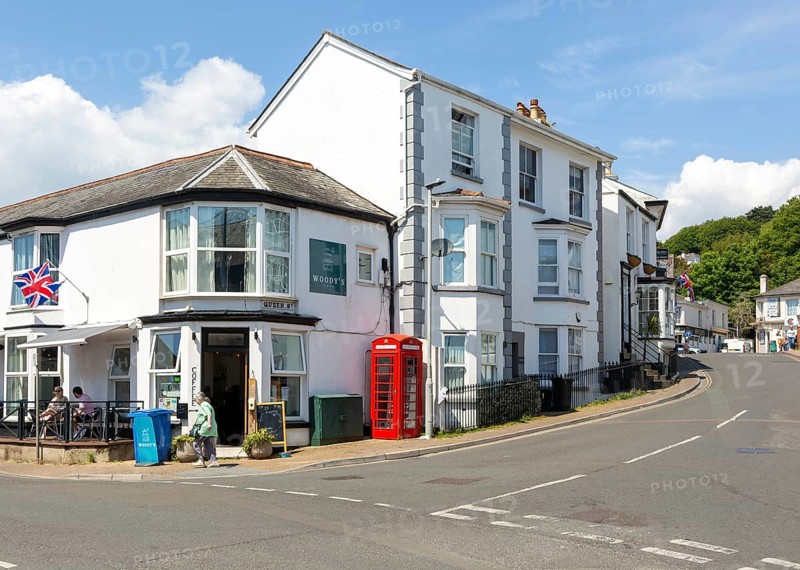 Historic buildings old red telephone box, Woody's cafe, Queen Street, Dawlish, south Devon, England, UK