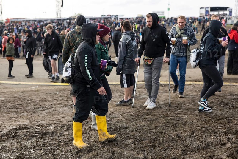 Festival visitors walk through mud in wellies at the Rock am Ring festival on Sunday, Nürburgring race track race track, 08/06/2025